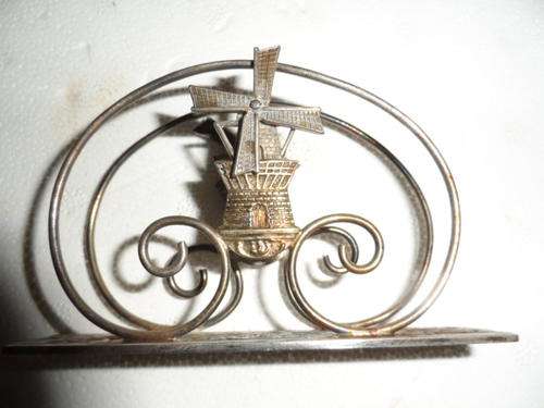 Lovely silver serviette holder with turning windmill blades.