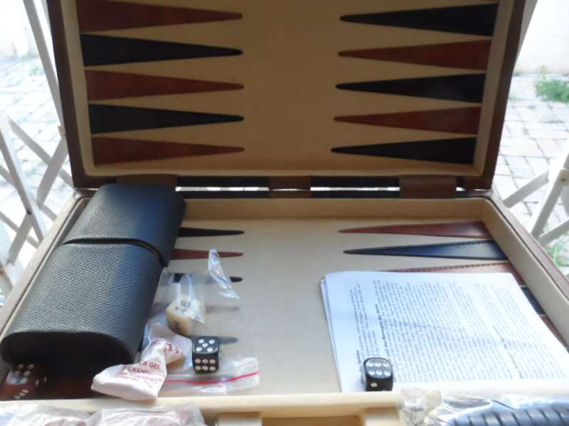 Beautiful Back gammon game in leather case and board like new.  all pieces there