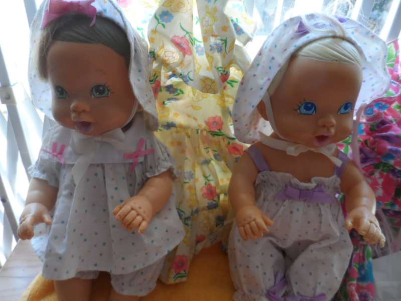 Two cuchiecoo dolls with original outfits plus 1 extra each and two bottles and 1 dummy