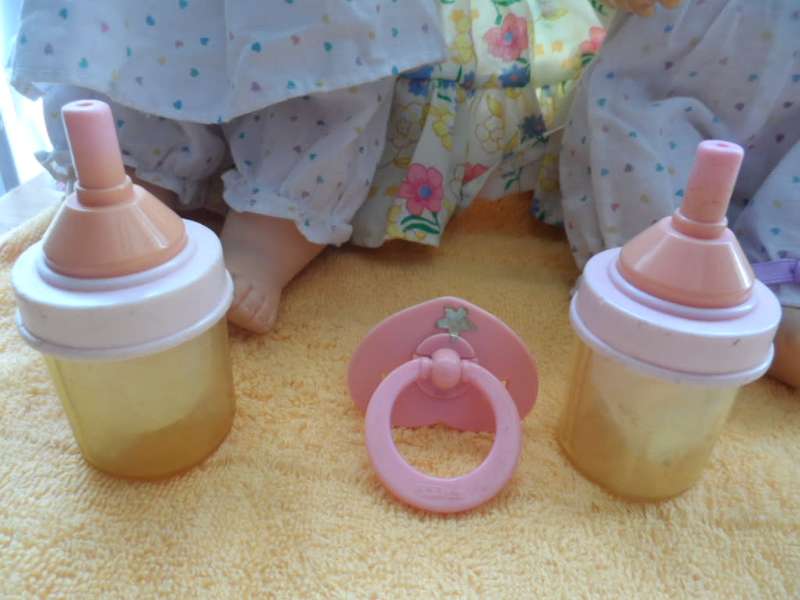 Two cuchiecoo dolls with original outfits plus 1 extra each and two bottles and 1 dummy