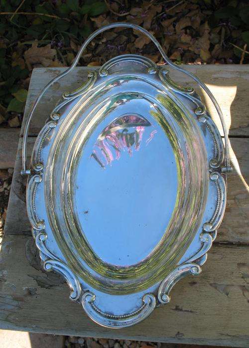Beautiful vintage silver plated serving dish with a handle on bun feet