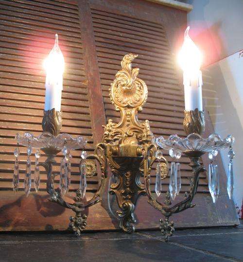 Large vintage matching pair of double light brass and crystal French wall sconces