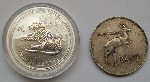 27.55 grams of silver in 1/2 Oz Tiger Coin and R1