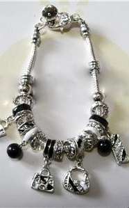 PRETTY PANDO BRACELET WITH BLACK & SILVER HANDBAG CHARMS.