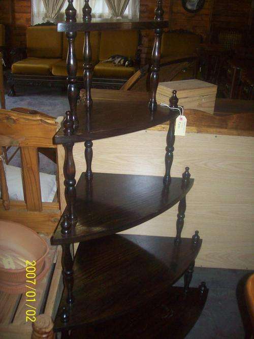 looks like pine, dark stain what not corner shelve, bottom shelve have stain marks on it.