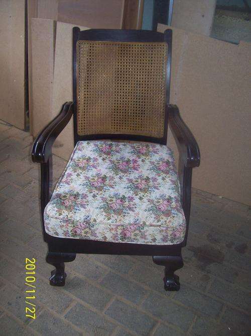 Ball & claw easy chair with cane backrest.