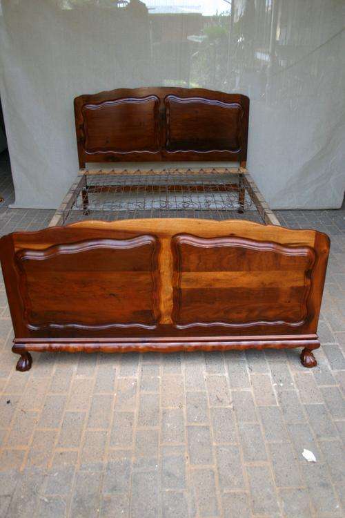 Stinkwood ball & claw double bed with headboard, footboard and mat.  No matress.