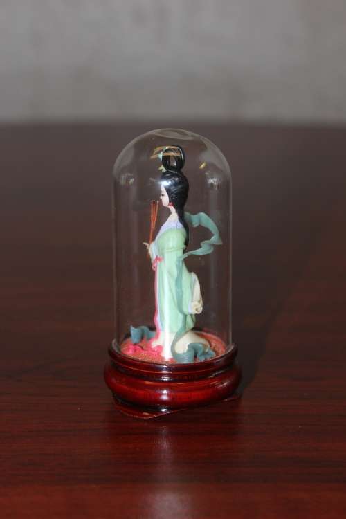 Vintage Hand Sculpted Miniature Japanese Geisha in green dress on wooden base with glass dome 8.6cm