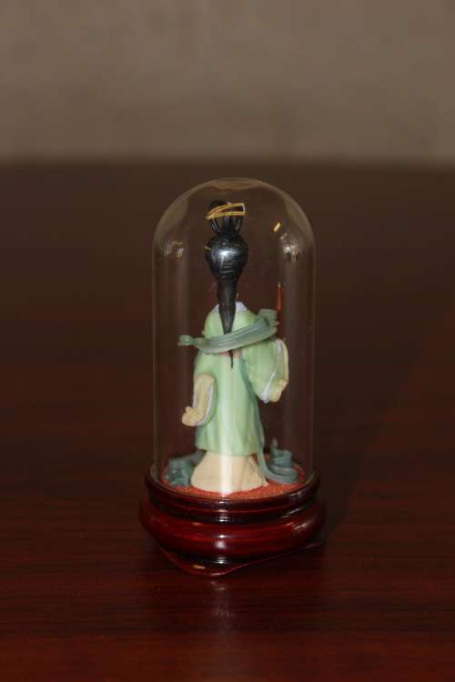 Vintage Hand Sculpted Miniature Japanese Geisha in green dress on wooden base with glass dome 8.6cm