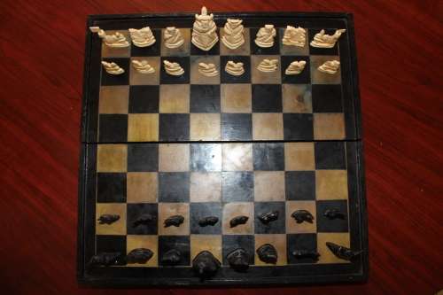ANTIQUE CHINESE HANDCARVED and STAINED BONE CHESS SET WITH LACQUERED WOODEN BOARD/CASE 34 BY 35 CM