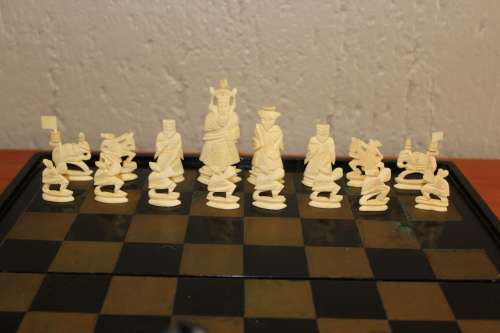 ANTIQUE CHINESE HANDCARVED and STAINED BONE CHESS SET WITH LACQUERED WOODEN BOARD/CASE 34 BY 35 CM