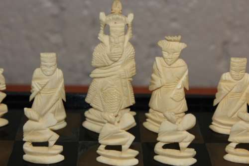 ANTIQUE CHINESE HANDCARVED and STAINED BONE CHESS SET WITH LACQUERED WOODEN BOARD/CASE 34 BY 35 CM
