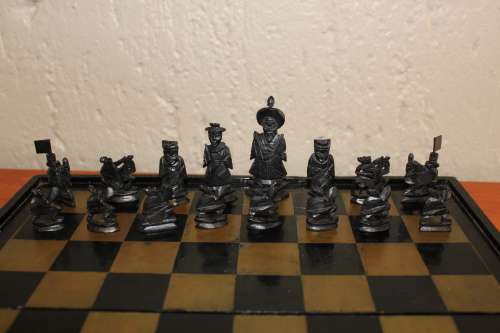 ANTIQUE CHINESE HANDCARVED and STAINED BONE CHESS SET WITH LACQUERED WOODEN BOARD/CASE 34 BY 35 CM