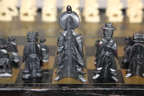 ANTIQUE CHINESE HANDCARVED and STAINED BONE CHESS SET WITH LACQUERED WOODEN BOARD/CASE 34 BY 35 CM