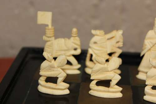 ANTIQUE CHINESE HANDCARVED and STAINED BONE CHESS SET WITH LACQUERED WOODEN BOARD/CASE 34 BY 35 CM