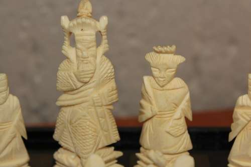 ANTIQUE CHINESE HANDCARVED and STAINED BONE CHESS SET WITH LACQUERED WOODEN BOARD/CASE 34 BY 35 CM