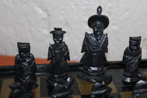 ANTIQUE CHINESE HANDCARVED and STAINED BONE CHESS SET WITH LACQUERED WOODEN BOARD/CASE 34 BY 35 CM