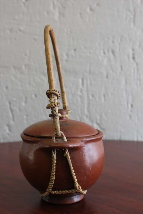 ANTIQUE CHINESE TERRACOTTA WATER POT WITH WOVEN CANE HANDLE MARKED ON BASE CIRCA EARLY 1900S