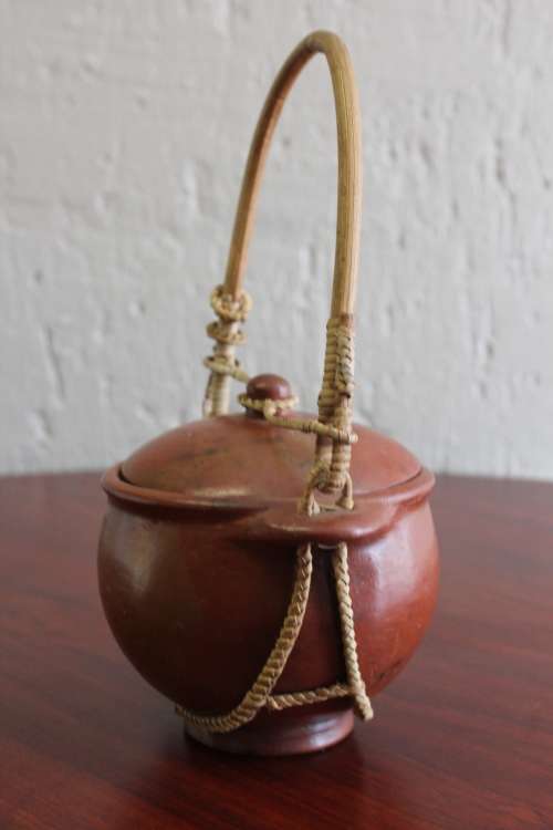 ANTIQUE CHINESE TERRACOTTA WATER POT WITH WOVEN CANE HANDLE MARKED ON BASE CIRCA EARLY 1900S