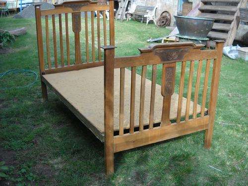 OAK BED WITH IRON BASE AND BOARD.