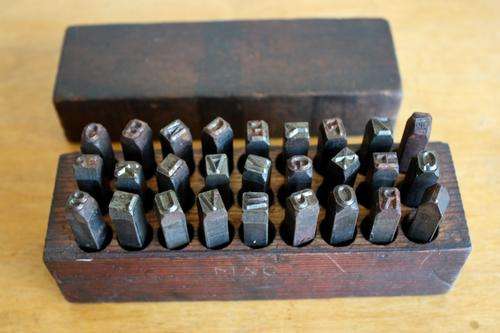 Metal alpabet stamp set- in original wooden box