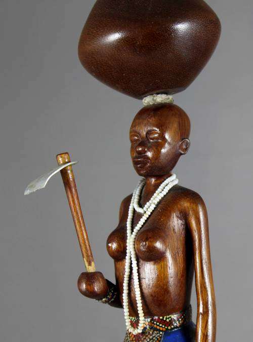 HR Mbhele - Woman Carrying Large Pot and hoe