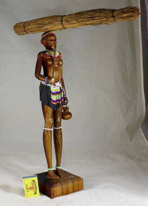 HR Mbhele - Woman Carrying Large Bundle of Reeds