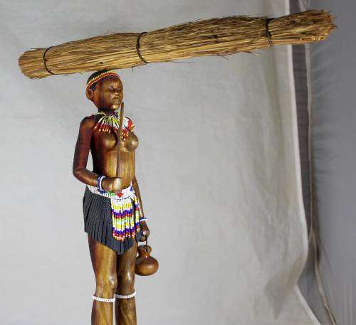 HR Mbhele - Woman Carrying Large Bundle of Reeds