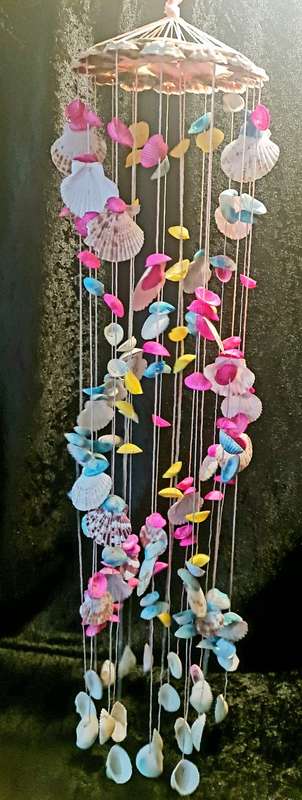 Fun and flirty. Pink, blue and yellow shell windchime