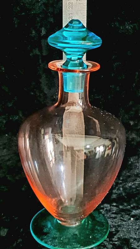Gorgeous footed bright blue and peach glass decanter.