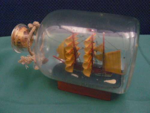 SHIP IN GLASS BOTTLE CORKED AND WOODEN STAND