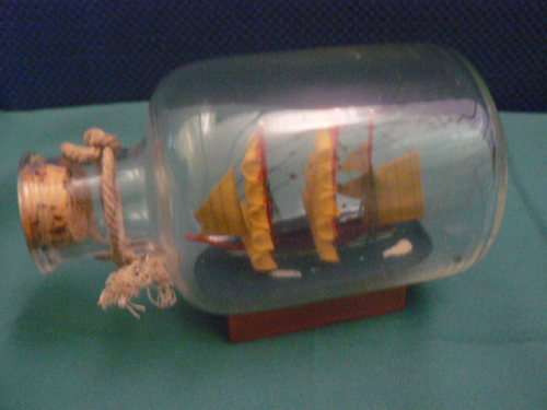 SHIP IN GLASS BOTTLE CORKED AND WOODEN STAND