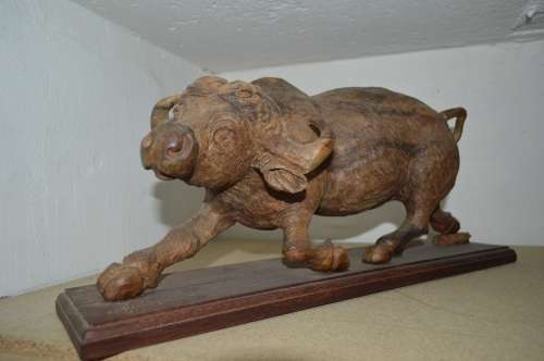 Very large from the 80's ironwood carved buffalo of rosewood base