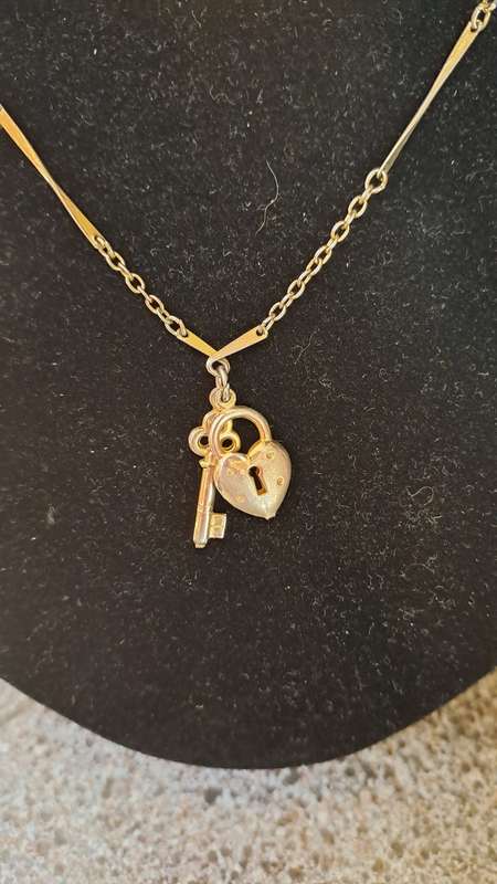 Gold toned necklace with heart and key