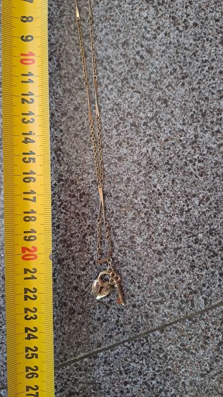 Gold toned necklace with heart and key