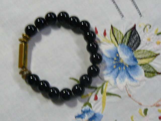 BANGLE WITH BLACK STONES , STRETCH WITH SOME GOLD TONE
