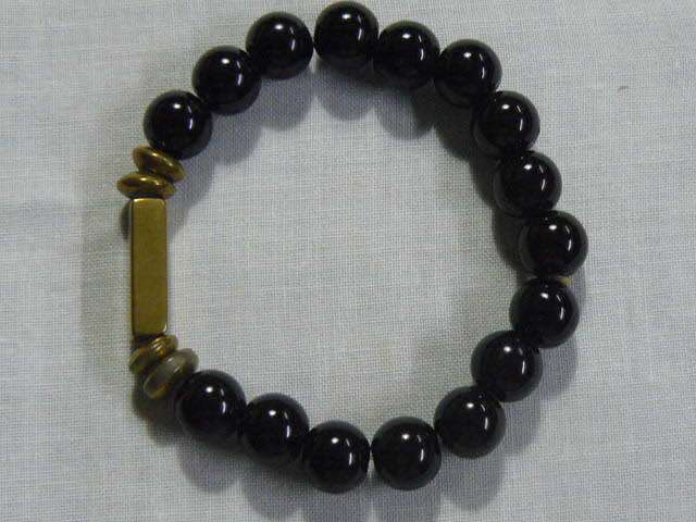 BANGLE WITH BLACK STONES , STRETCH WITH SOME GOLD TONE