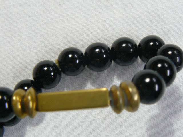 BANGLE WITH BLACK STONES , STRETCH WITH SOME GOLD TONE