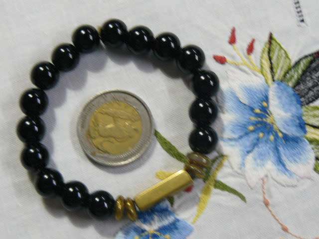 BANGLE WITH BLACK STONES , STRETCH WITH SOME GOLD TONE