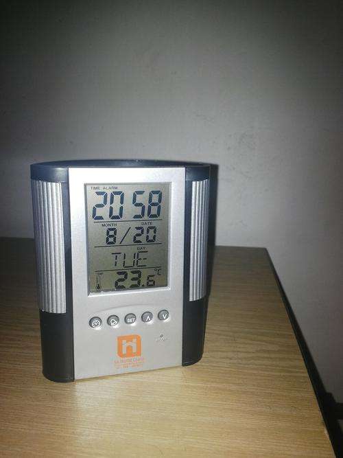 Upright little clock with temperature and alarm.