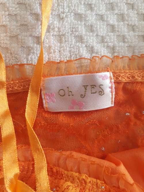 LADIES ORANGE TOP WITH A FEW MARKS ON IT