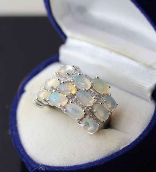 BROAD BAND STERLING SILVER RING SET WITH AAA QUALITY RAINBOW WHITE OPALS.