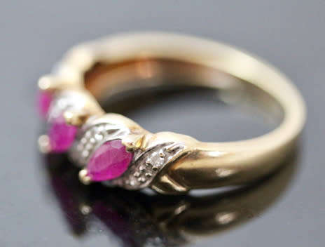 VINTAGE 9CT HALF ETERNITY YELLOW AND WHITE GOLD RUBY AND DIAMOND RING. 375