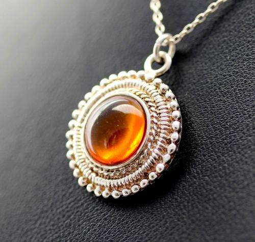 NATURAL BALTIC AMBER PENDANT. INCLUDES STERLING SILVER CHAIN