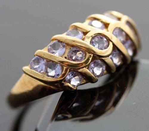 9CT YELLOW GOLD TANZANITE RING. UNUSUAL LATTICE-WORK SETTING. BIRMINGHAM ASSAY. DATE MARK 2000