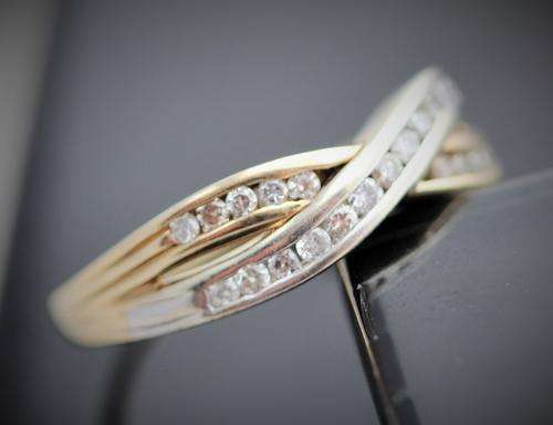 DIAMOND CROSS OVER RING YELLOW AND WHITE 9ct GOLD.
