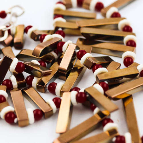HANDCRAFTED BRONZE-COATED HEMATITE, CORAL AND OSTRICH SHELL NECKLACE. *JEWELLER EVALUATION R2`400*