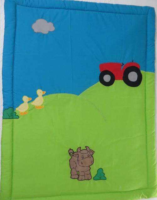 Baby's cot comforter with farm theme