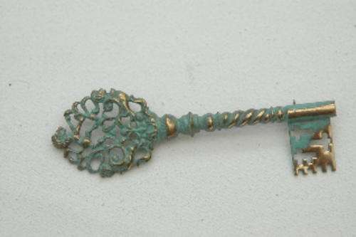 A brooch in pressed metal (antique finish, very effective)