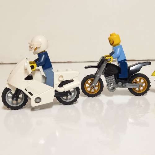 Four Lego Minifigurines And Lego Vehicles